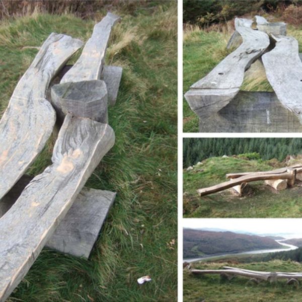 A split oak bench high on a cliff overlooking Afon Dwyryd